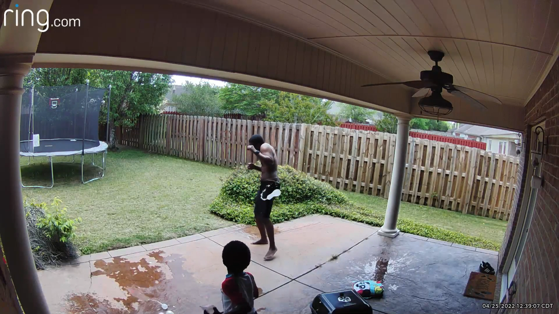 Father and young son having fun over a water balloon fight