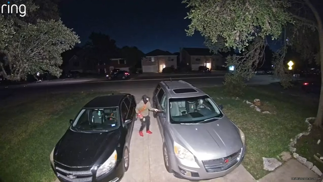 A stranger attempts to break into a car but is deterred by the Ring Motion Warning feature.