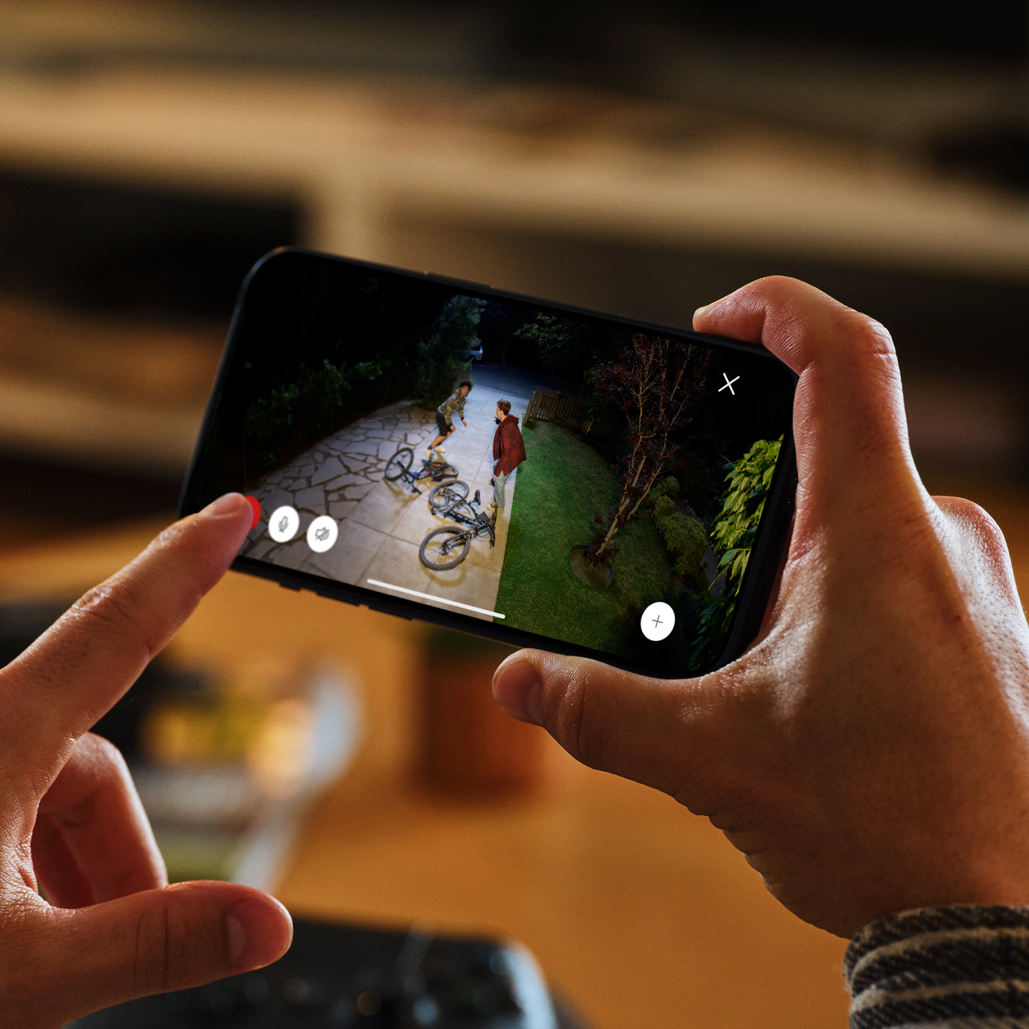 Floodlight Cam Pro (Newest Model) - A man on a ladder with a tool belt installs Floodlight Cam Pro (2nd Gen) onto the side of a home.