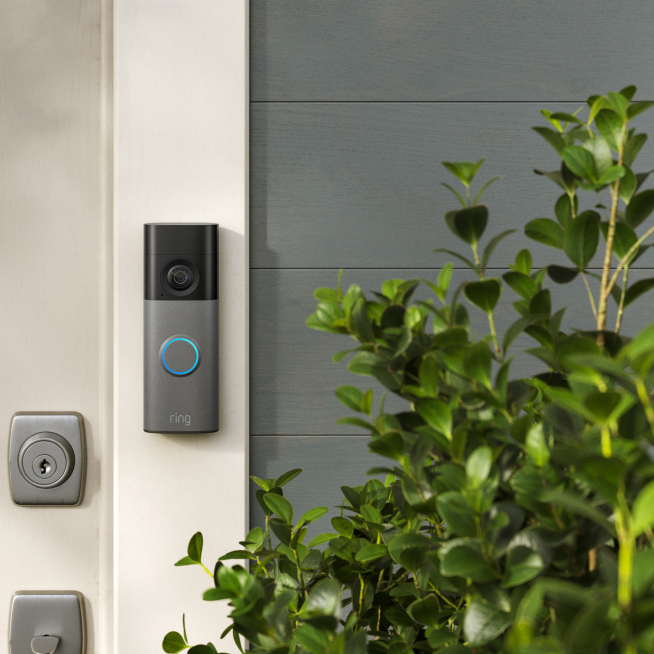 Video doorbell beside front door.