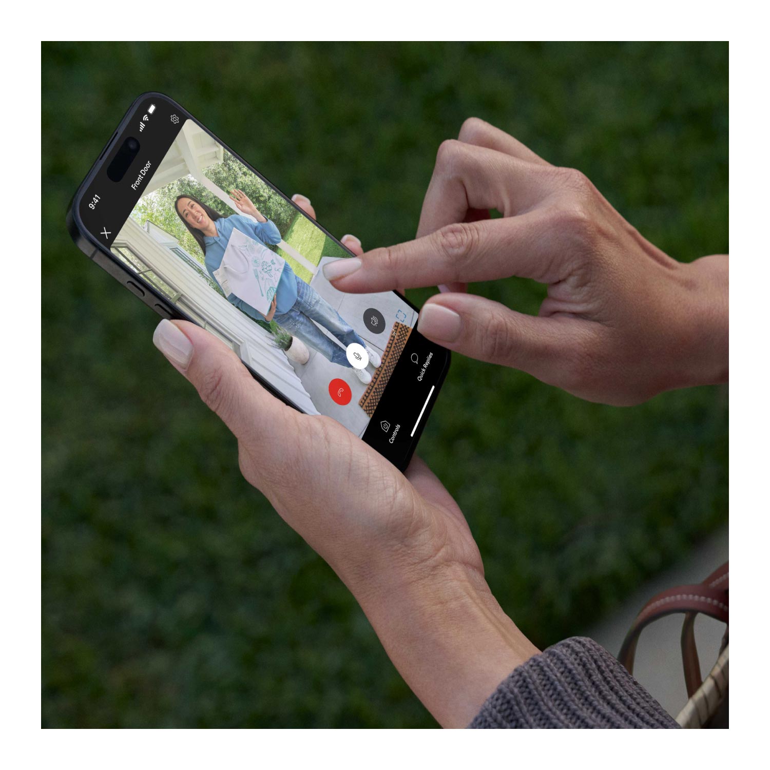 Wired Doorbell Plus (Newest Model) (Featuring Retinal 2K) - Close-up of hands holding a smartphone displaying daytime video footage of a food delivery woman carrying a restaurant to-go bag, shown in full length from head to toe and captured in daylight conditions.
