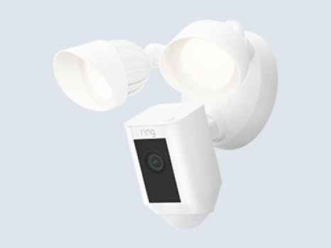 A white Ring Floodlight Cam Wired Plus with two adjustable LED floodlights and built-in security camera.