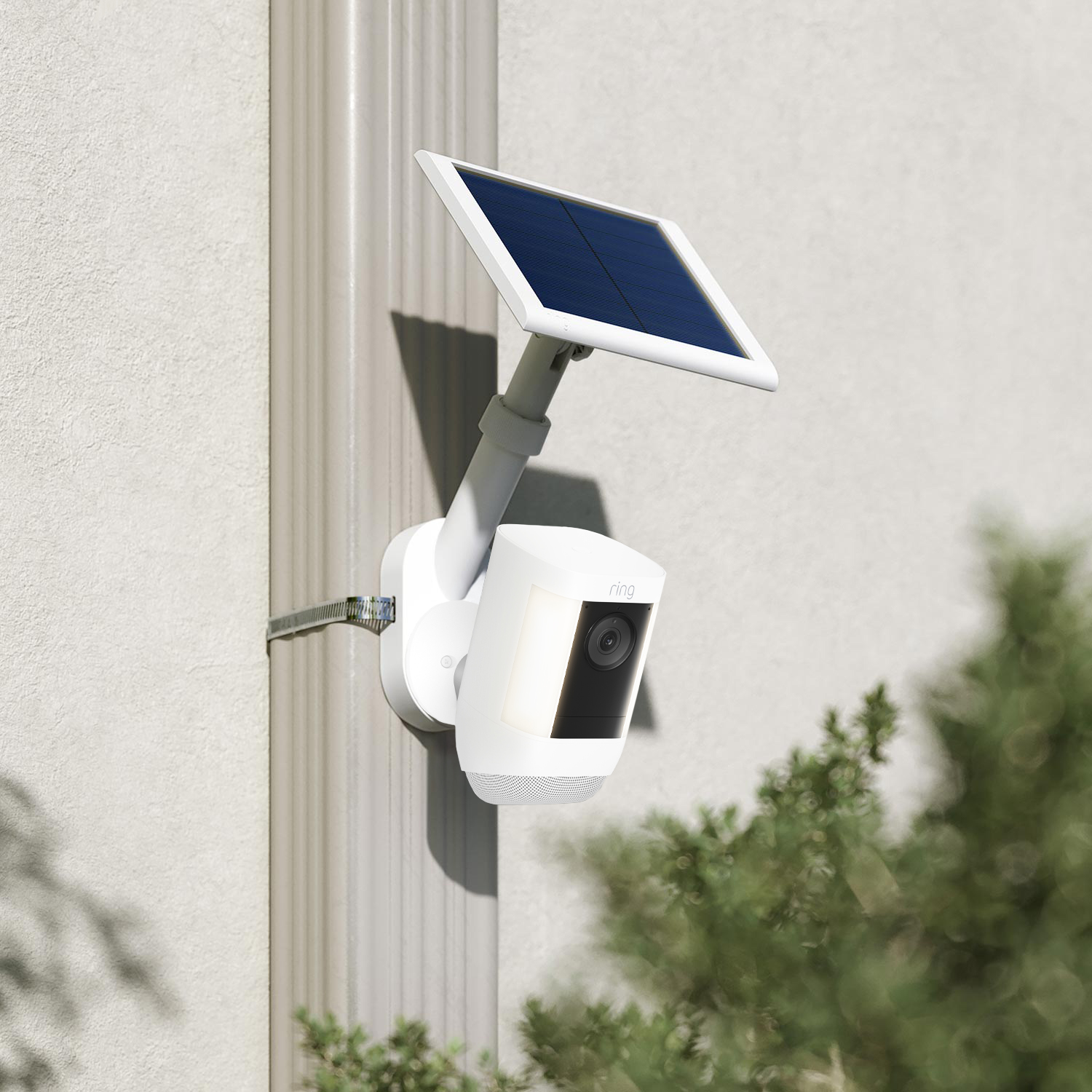 Spotlight Cam Pro Solar + Pole and Wall Mount (2K Video with Ring Vision) - White Spotlight Cam Pro Solar mounted to grey wall outside with the Ring accessory Pole and Wall Mount
