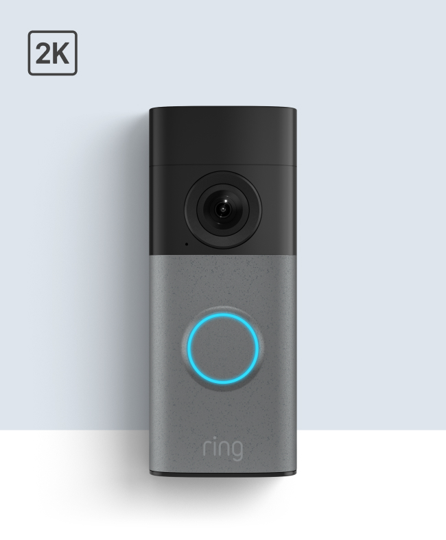 Ring video doorbell with black camera top, gray body, blue illuminated button, and 2K resolution indicator.
