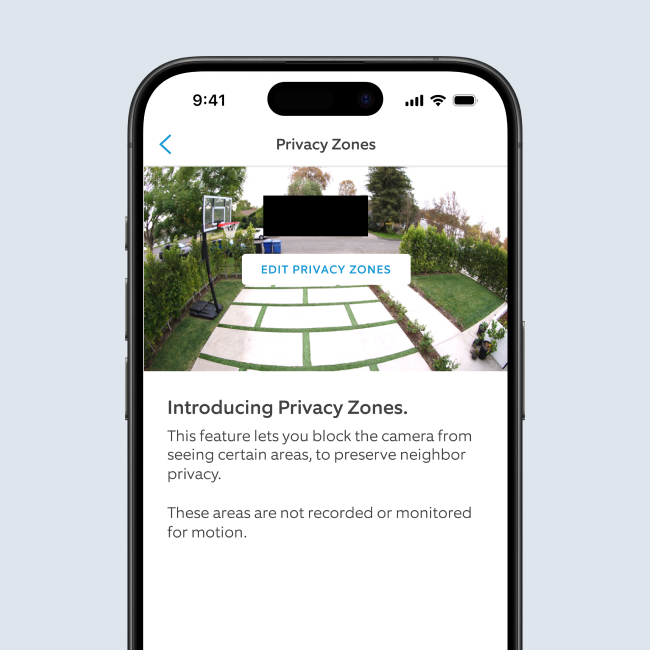 Smartphone screen showing security camera view in Ring app’s Privacy Zones feature, with blacked-out areas for privacy.