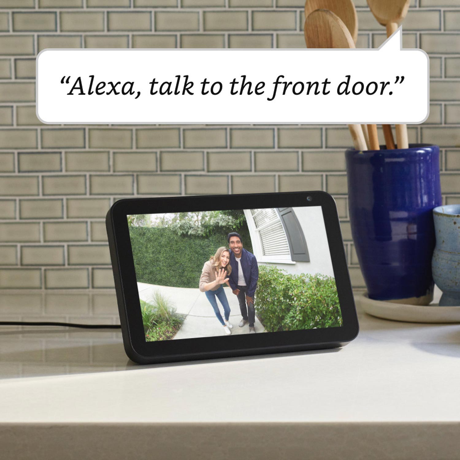 Video Doorbell Wired (for Certified Refurbished) - On a kitchen countertop, an Echo Show 5 shows 2 people looking into camera of Video Doorbell. Text reads: 