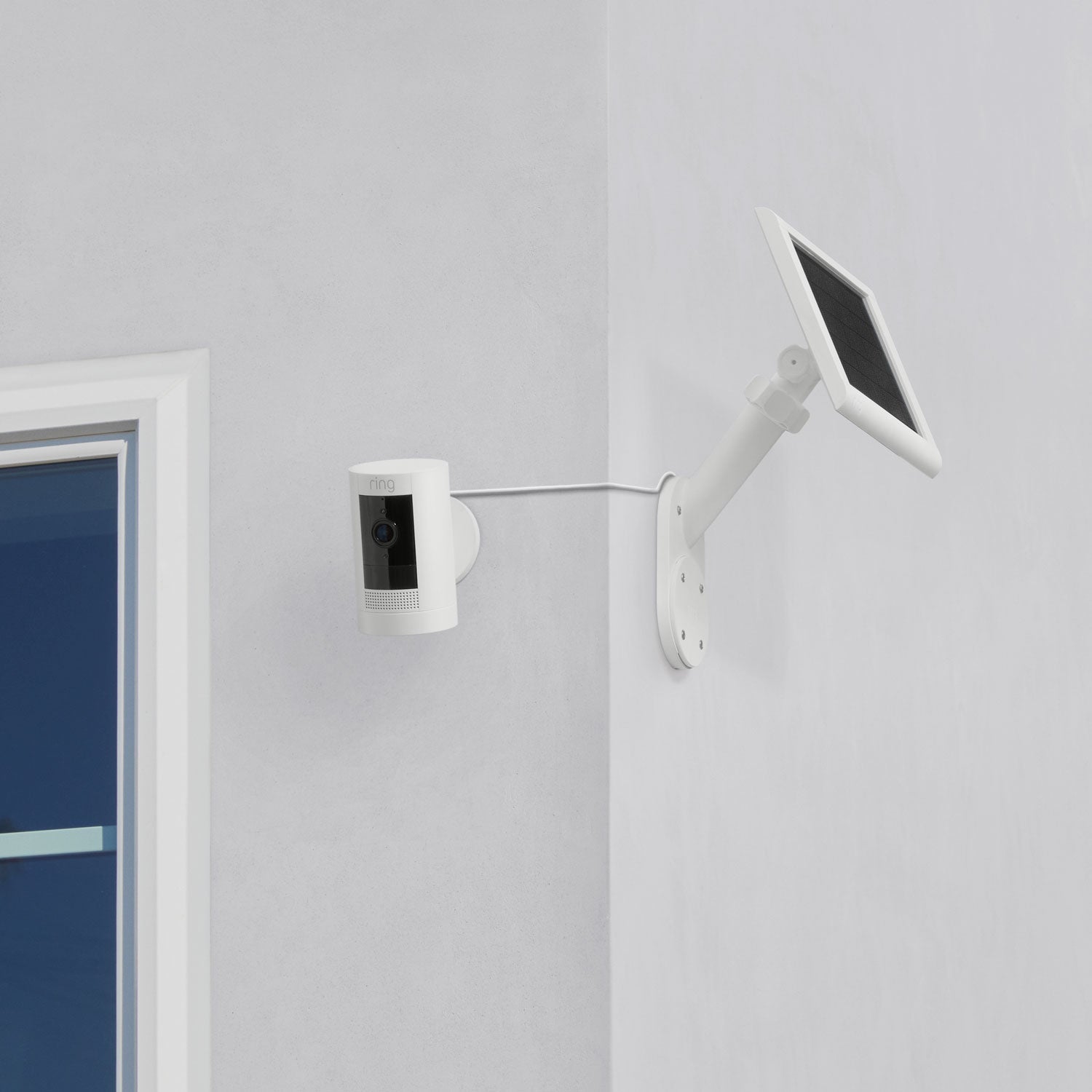 Wall Mount for Solar Panels and Cams - Installed on corner of home, Wall Mount for Solar Panels and Cams in white on one wall and detached Stick Up Cam on other wall.