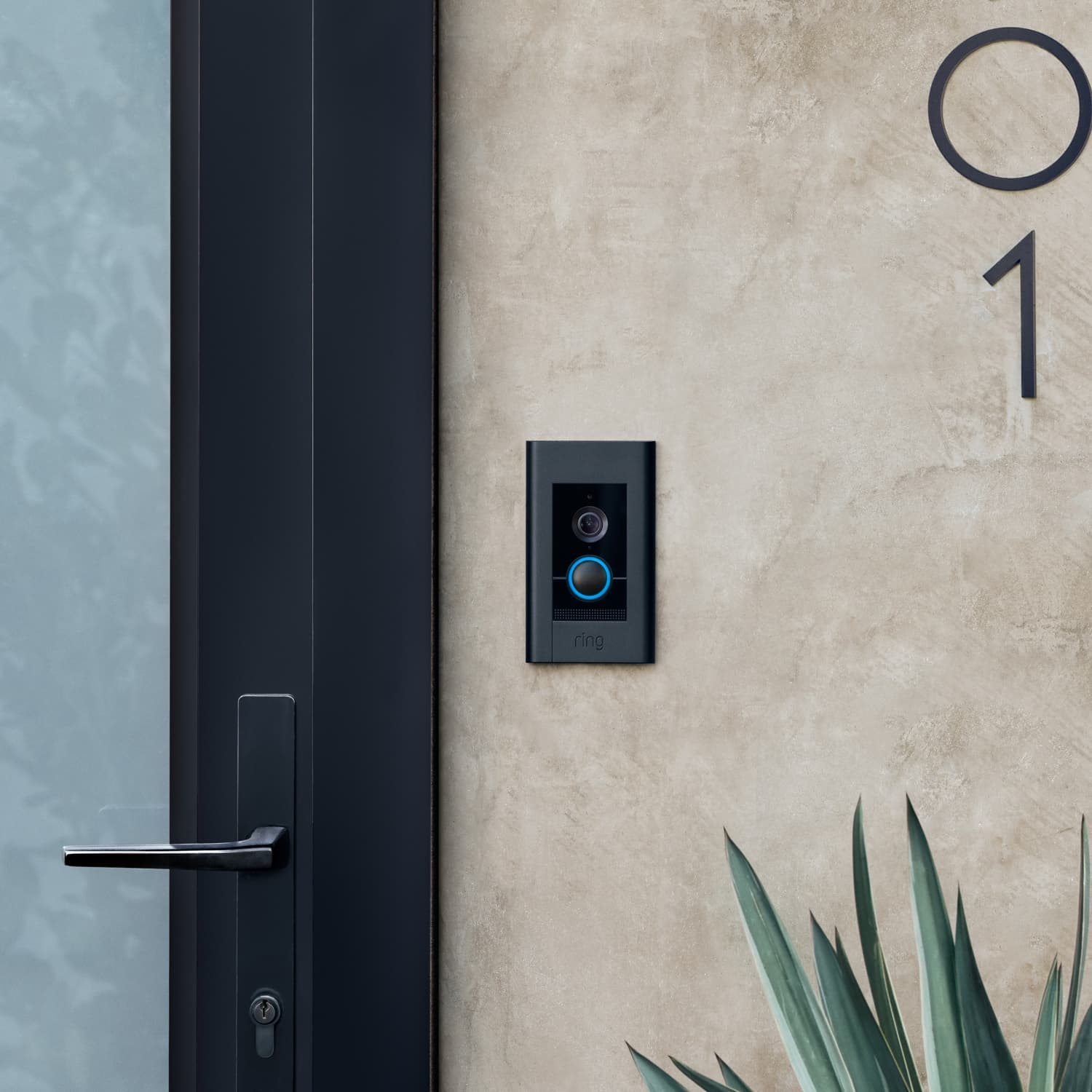Video Doorbell Elite (Power over Ethernet) - Video Doorbell Elite with satin black finish mounted on a beige wall next to a front door.