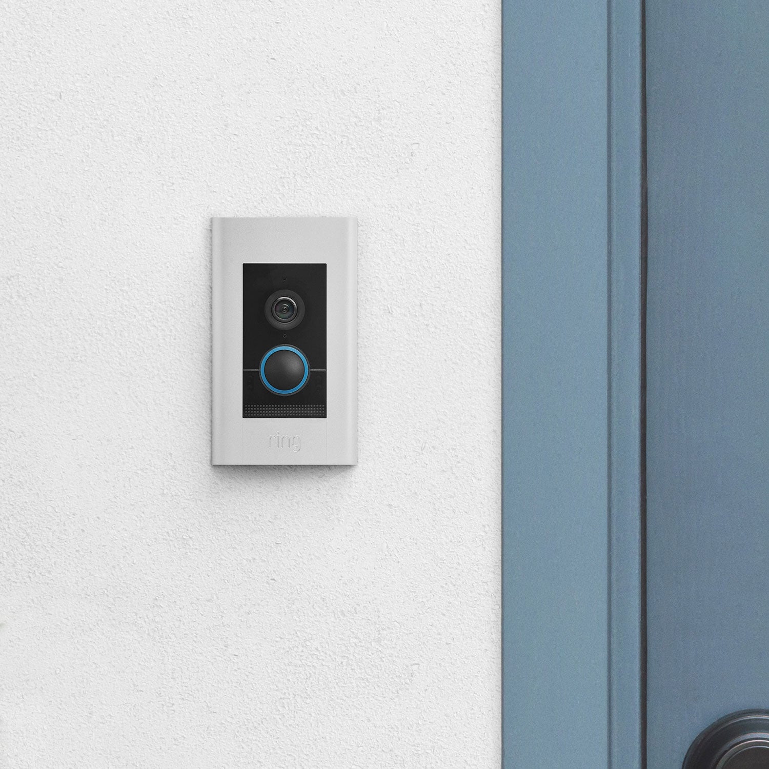 Video Doorbell Elite (Power over Ethernet) - Video Doorbell Elite with satin nickel finish mounted on a concrete wall next to a front door.
