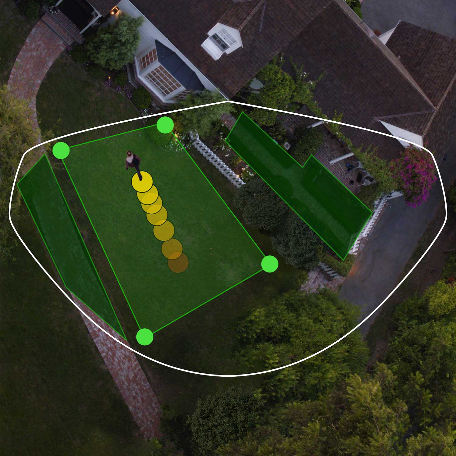 Floodlight Cam Pro (Plug-In) - Aerial view of front of house showing bird's eye view zones in green. Person walks toward front door, their path indicated by yellow dots.