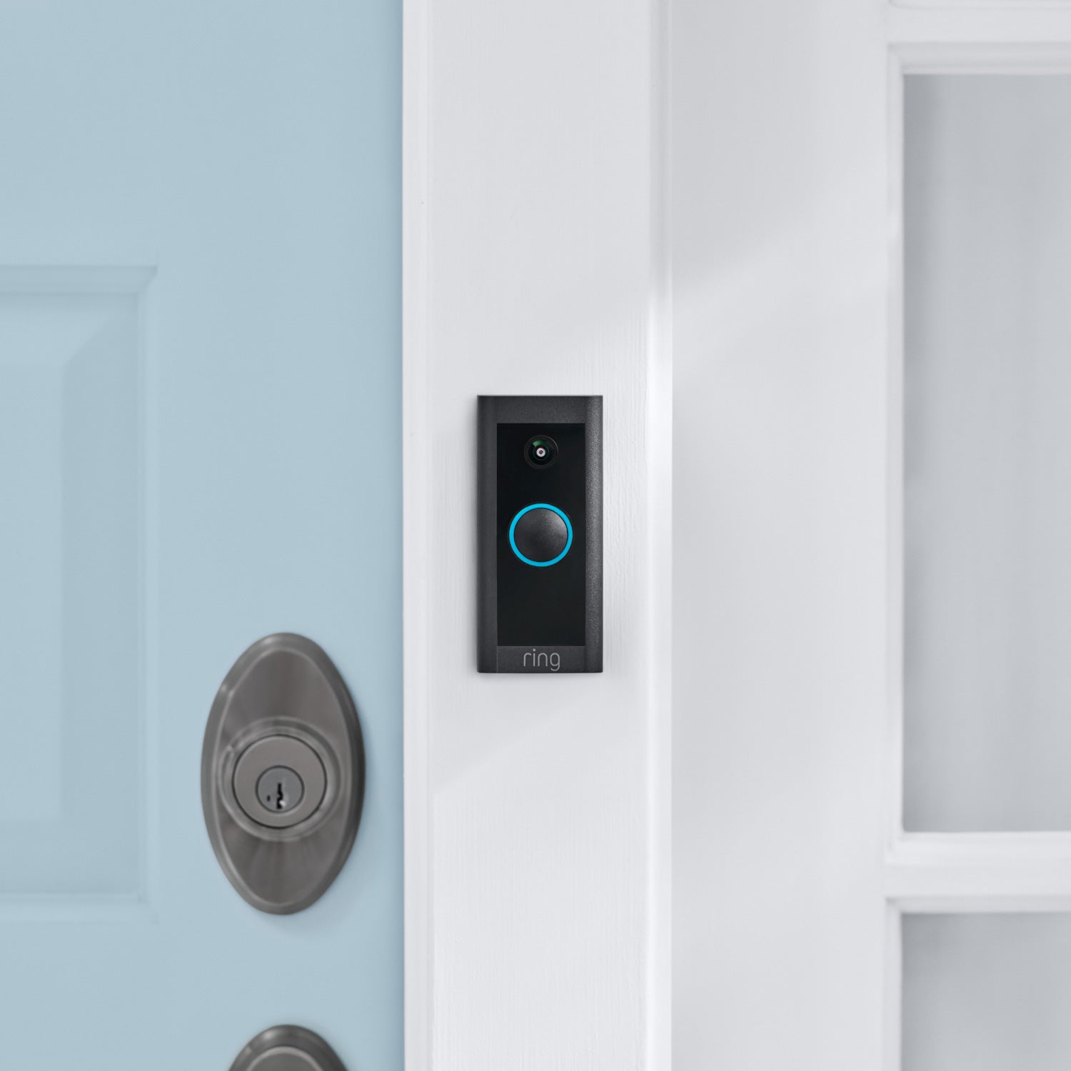 Video Doorbell Wired - Video Doorbell Wired in black, installed on exterior of home next to light blue front door.