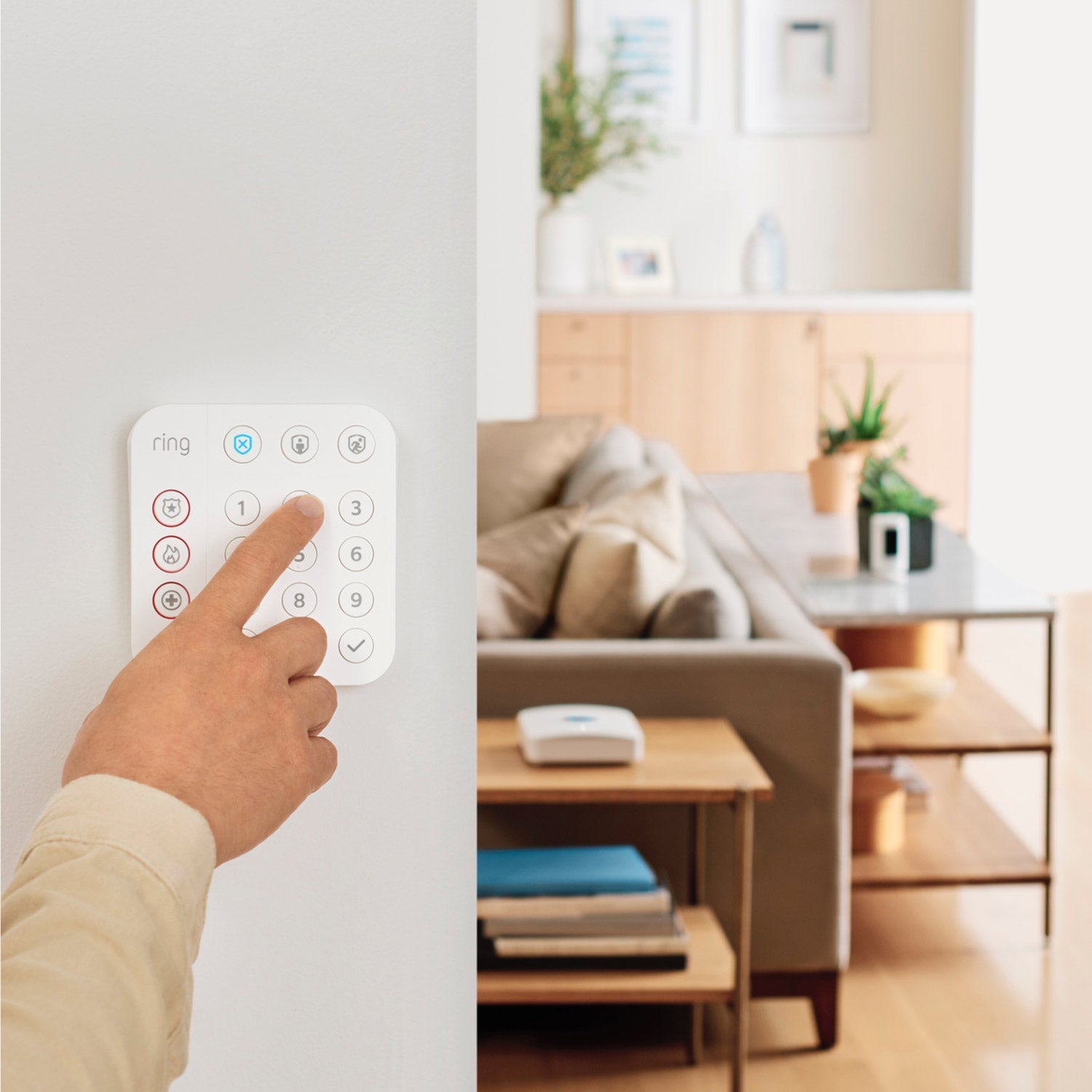 Alarm Pro, 13-Piece Kit (with built-in eero Wi-Fi 6 router and additional eero 6 Wi-Fi Router) - Inside a home, close-up of finger pressing button on keypad of 13-piece Alarm Pro Security Kit.