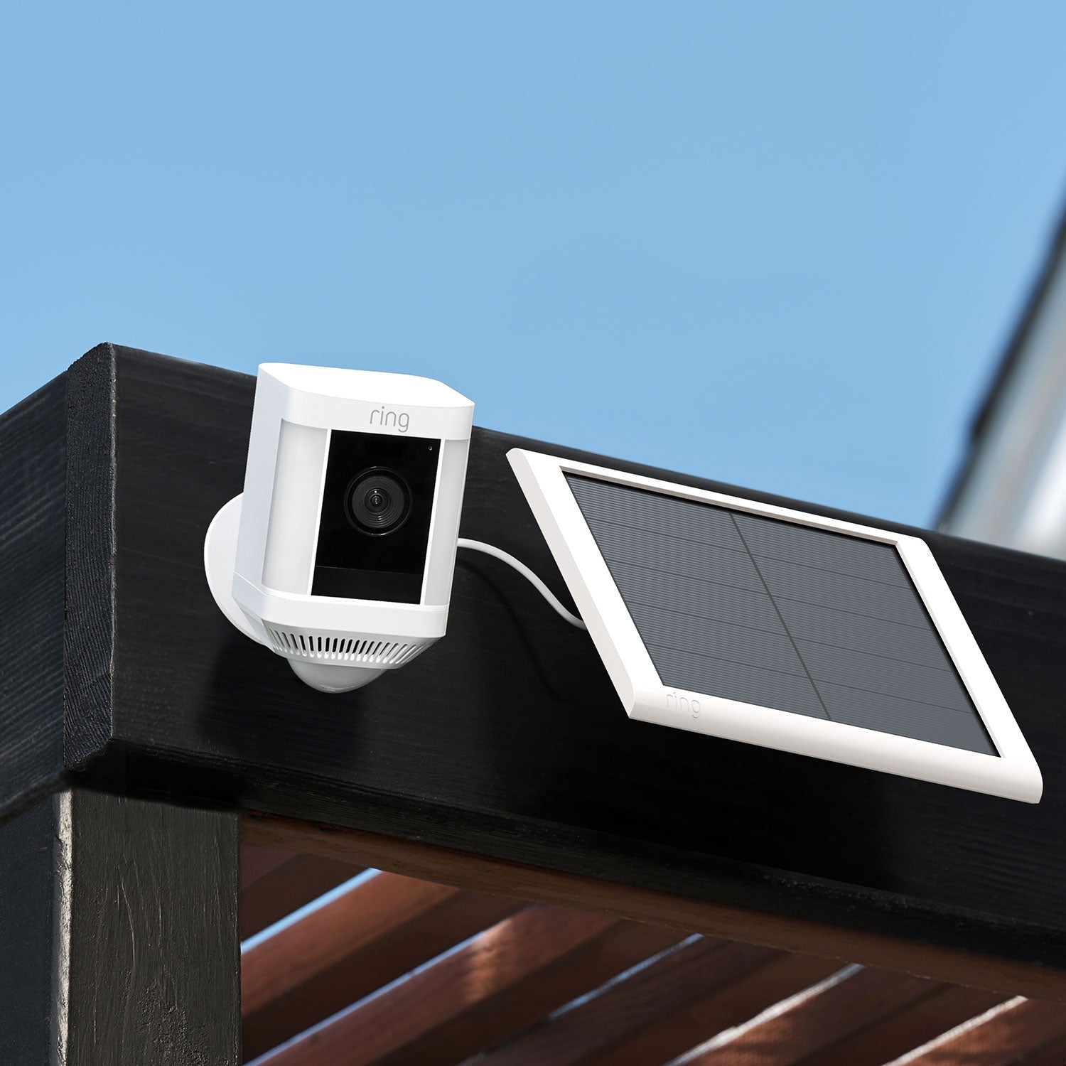 2-Pack Spotlight Cam Plus (Solar) - Spotlight Cam Plus and Solar Panel mounted to the side of a pergola.
