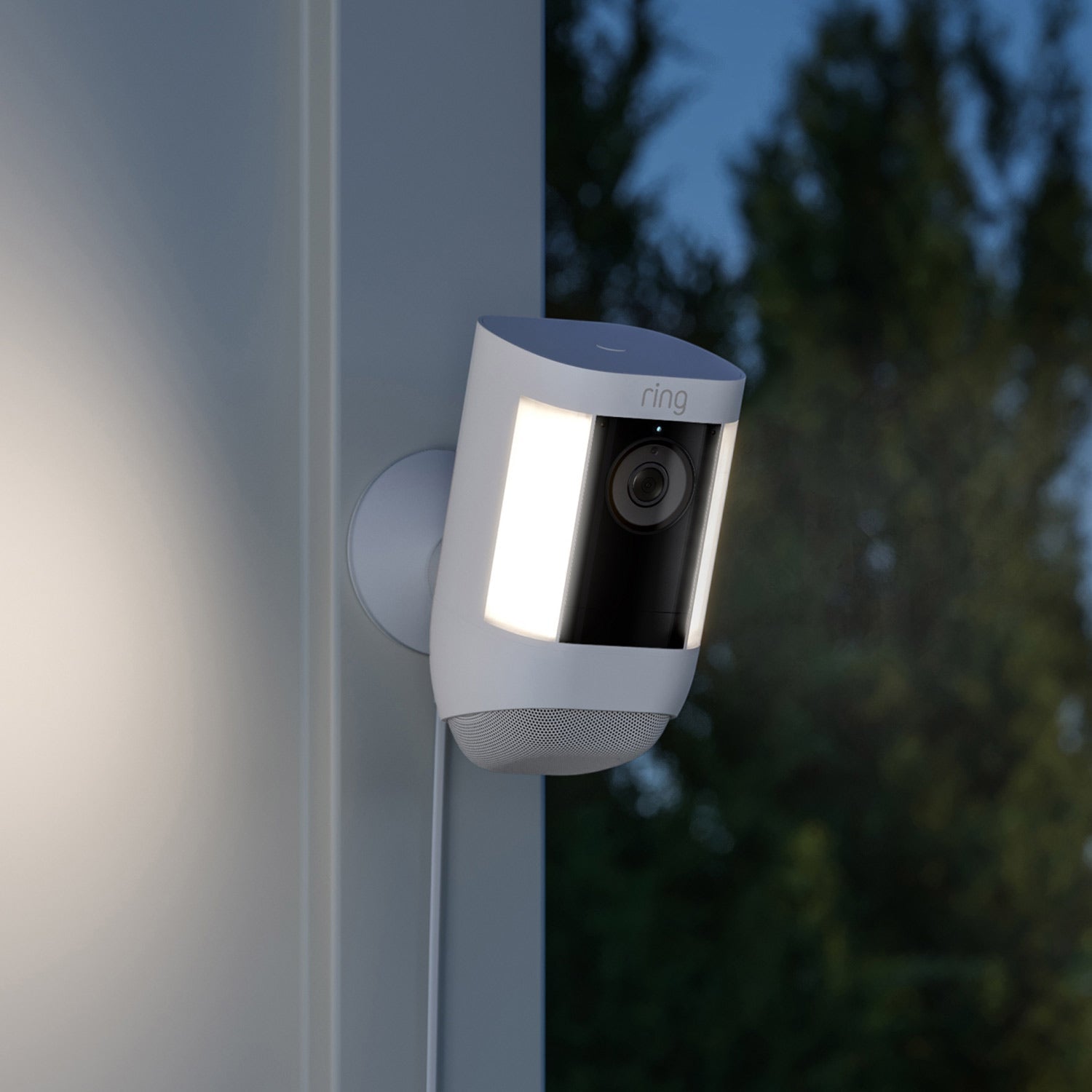 2-Pack Spotlight Cam Pro (Plug-In) - Spotlight Cam Pro, Plug-In model in white mounted on exterior corner of home with both lights illuminated.