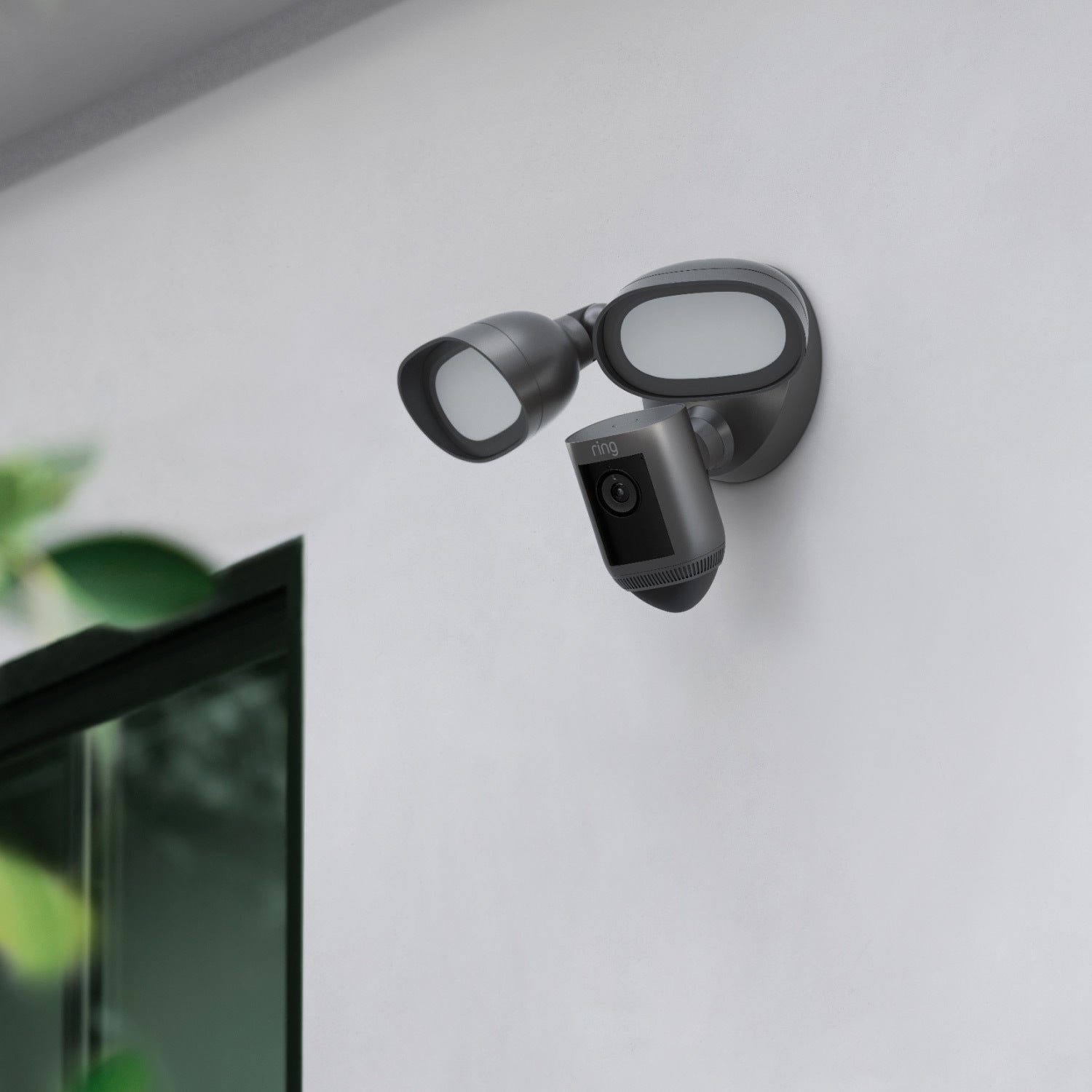 Floodlight Cam Wired Pro (Premium Colors) - Floodlight Cam Wired Pro with graphite finish mounted on an exterior wall of a home.