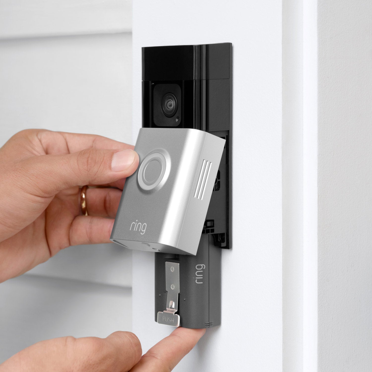 Battery Doorbell Plus (Video Doorbell) (for Certified Refurbished) - Close-up of two hands installing battery pack on Battery Doorbell Plus with satin nickel finish.