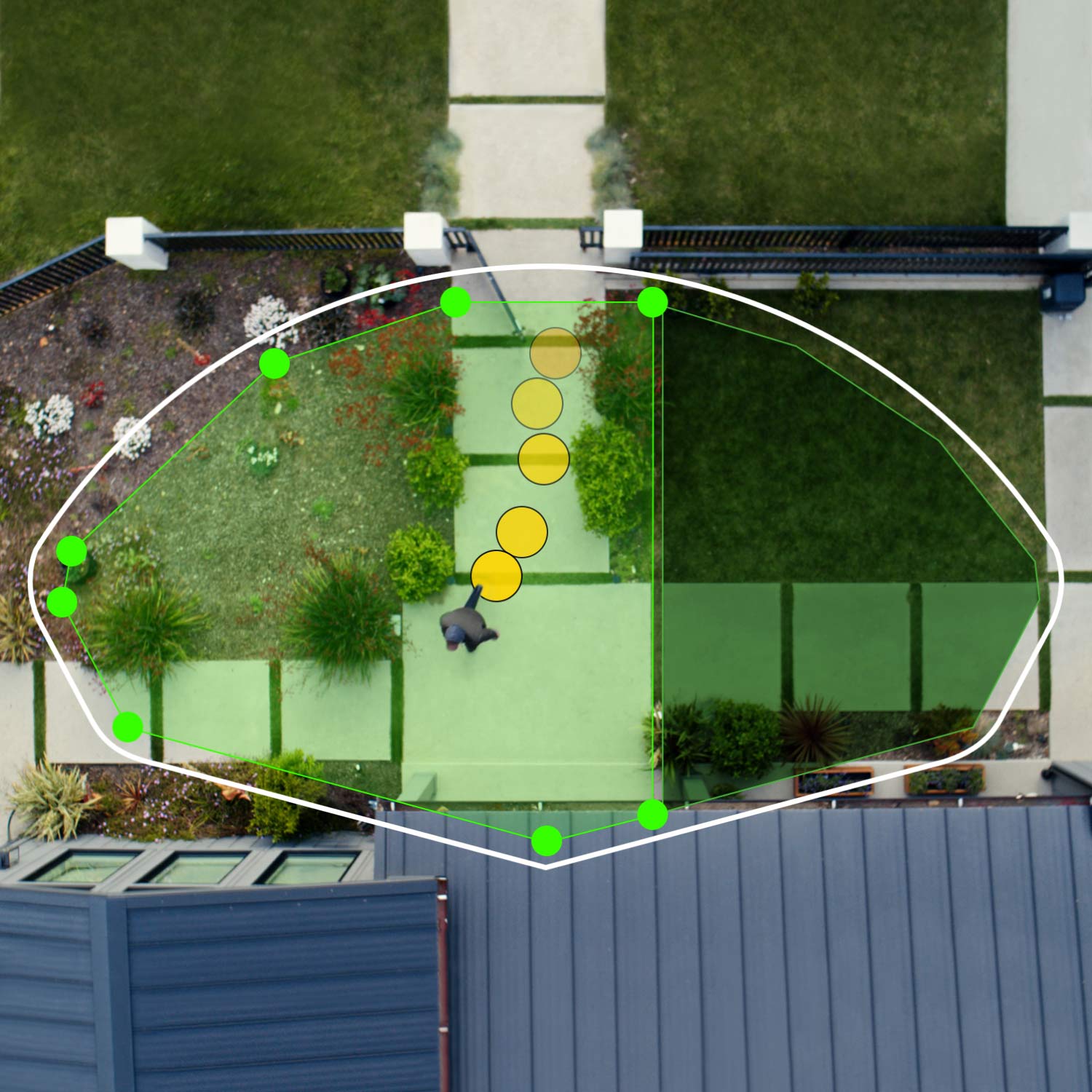 Wired Doorbell Pro (Formerly: Video Doorbell Pro 2) - Aerial view of front of house showing bird's eye view zones in green. Person walks toward front door, their path indicated by yellow dots.