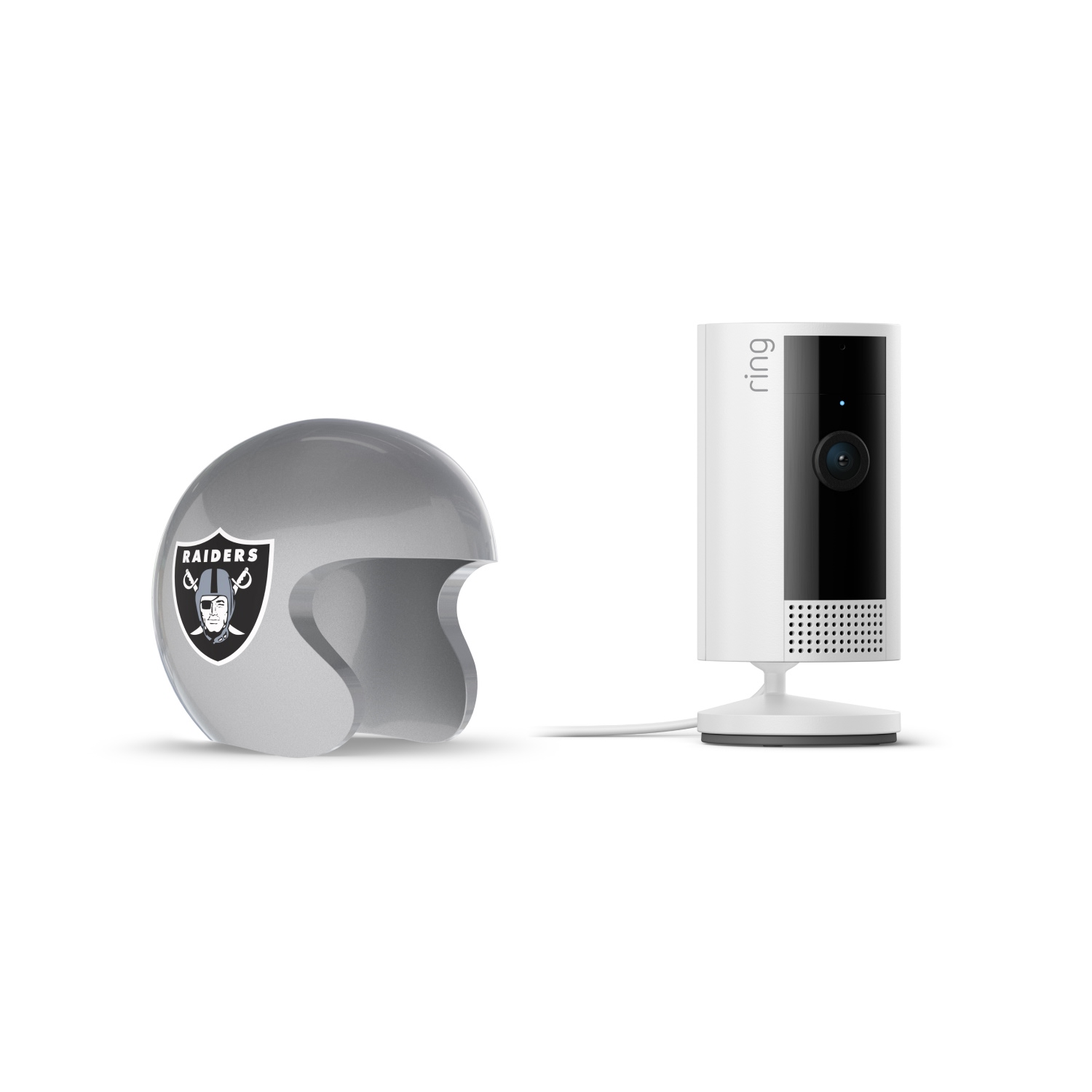 Indoor Cam, White + NFL Game Day Cam Cover — AFC - White Ring indoor camera on a stand beside a glossy gray Raiders-themed mini helmet on a white background.