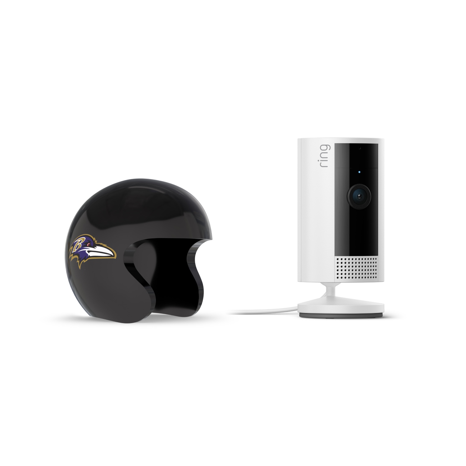 Indoor Cam, White + NFL Game Day Cam Cover — AFC - Black Baltimore Ravens mini helmet beside a white Ring indoor camera on a stand with power cable, set against a plain white background.