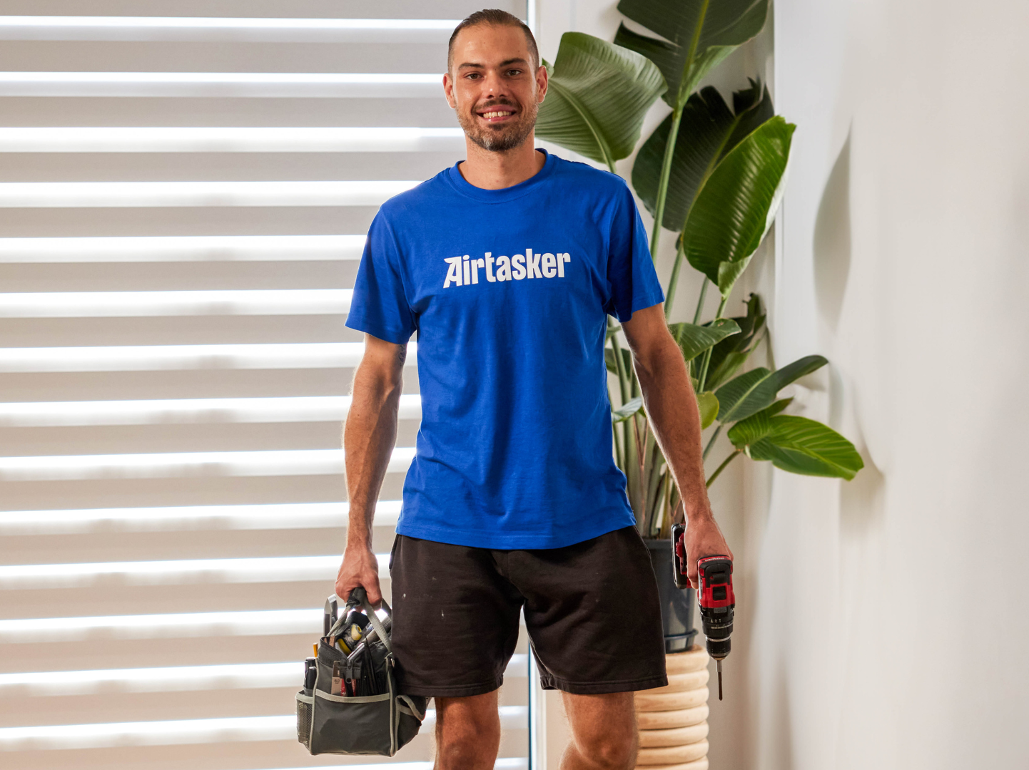 Ring Airtasker Easy Installation Offer. Man in airtasker Tshirt holding tools