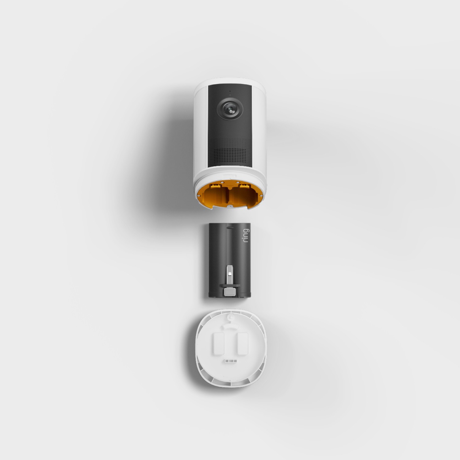 Spotlight Cam 4K Plus - Battery:Exploded view of a white cylindrical indoor camera with lens, showing its yellow interior, removable black battery pack, and white back cover.