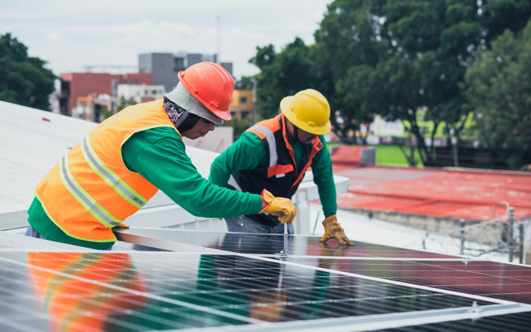 Two contractors installing solar panels