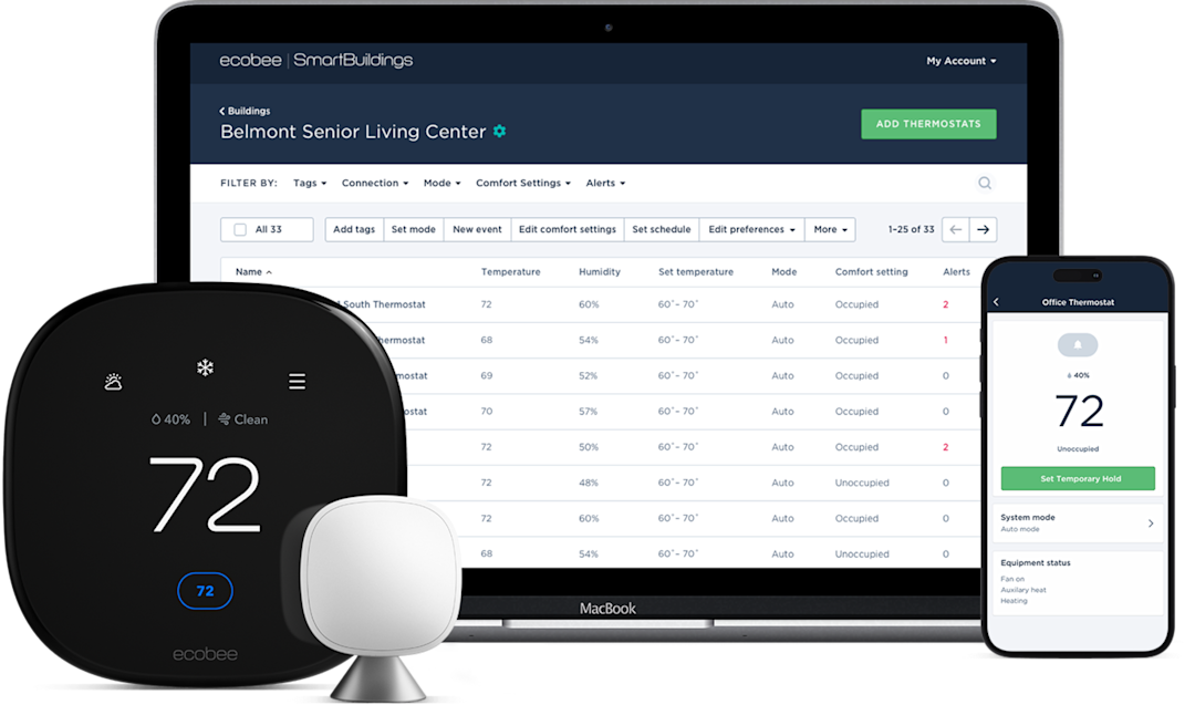 a computer and phone showing the ecobee "my buildings" dashboard, with a thermostat