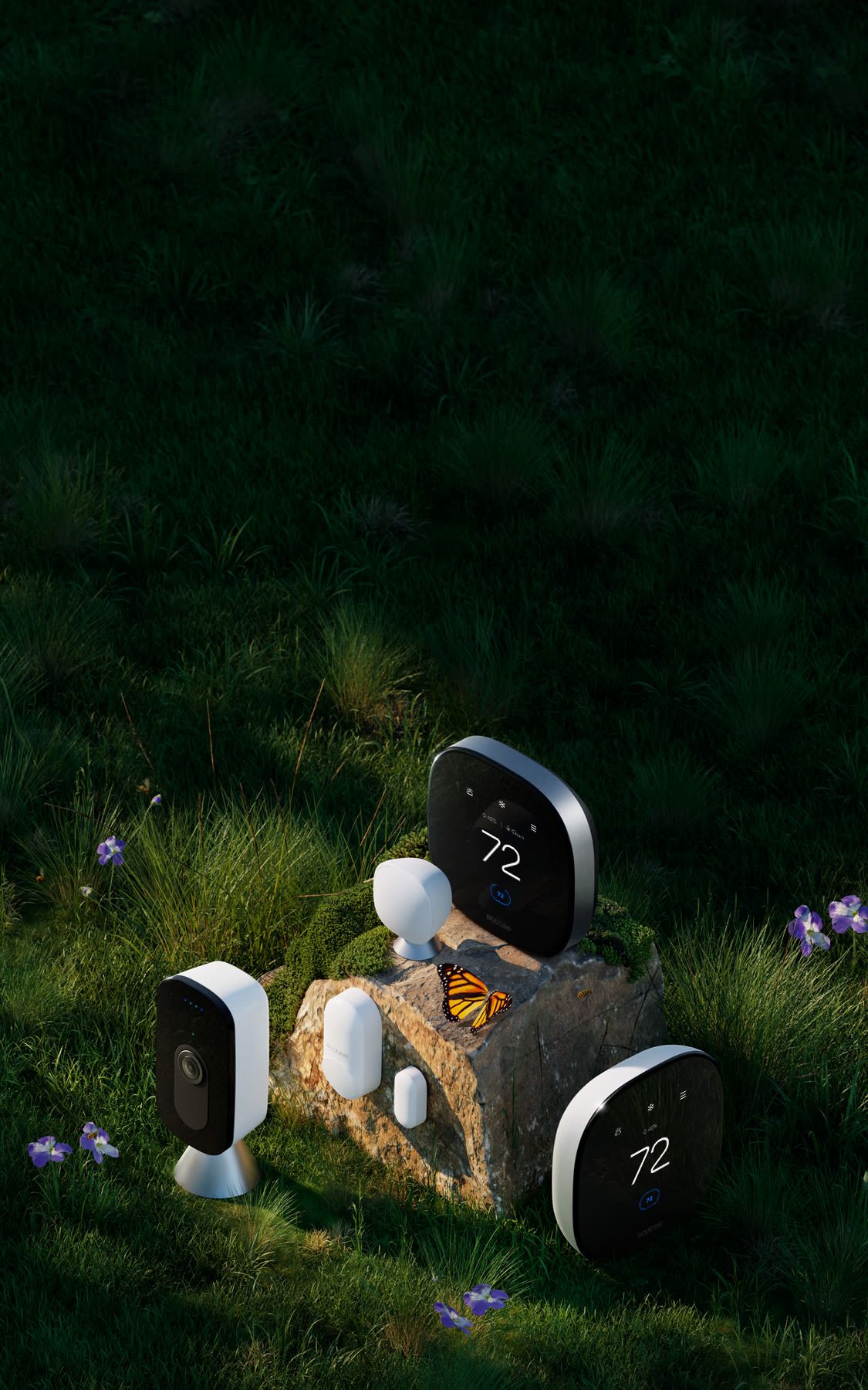 ecobee Smart Thermostat Premium, Smart Thermostat Enhanced, Smart Camera, and sensors sit on a rock in grass with a butterfly and flowers.