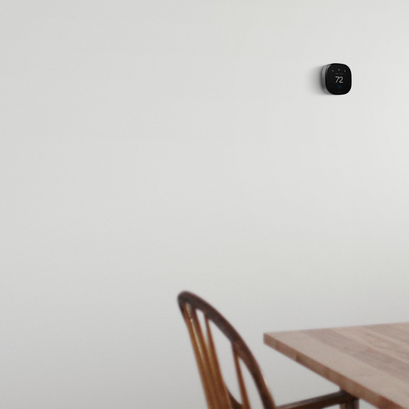 ecobee thermostat on a wall next to a table