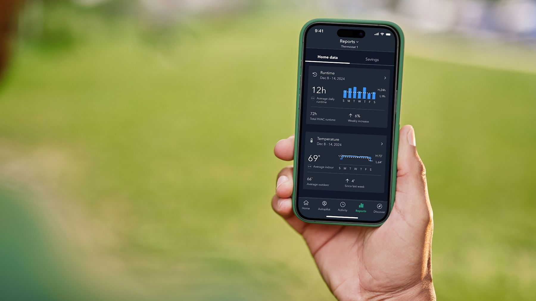 A person holding their cell phone that's displaying ecobee's Home Energy Report in the ecobee app on their screen.