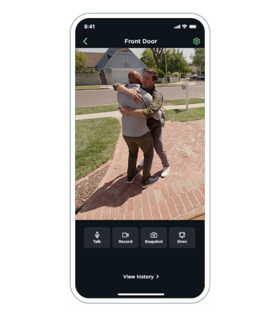A phone screen shows two men hugging on a driveway as seen from the doorbell camera. 