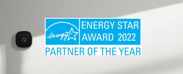 A thermostat on a white wall in the background . In the foreground, an Energy Star Award 2022 - Partner of the Year badge is displayed.