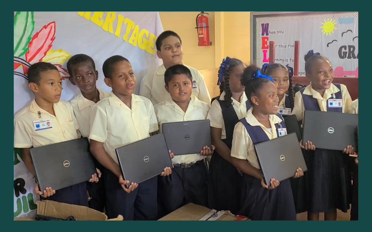 Students in Guyana holding the laptops donated by ecobee and Generac.