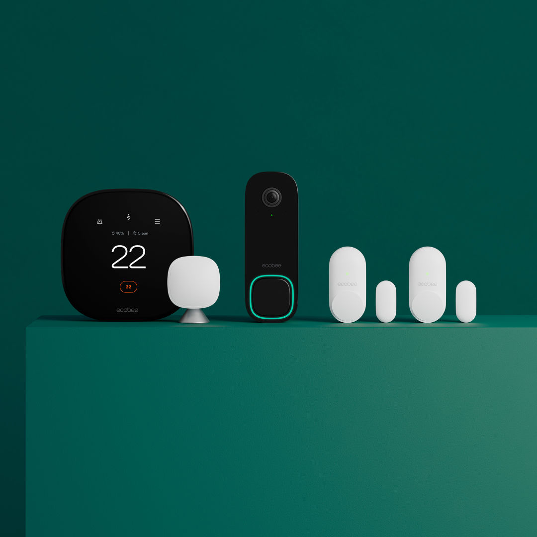 ecobee thermostat, Smart Doorbell Camera and sensors sitting on a green ledge in front of a green background.