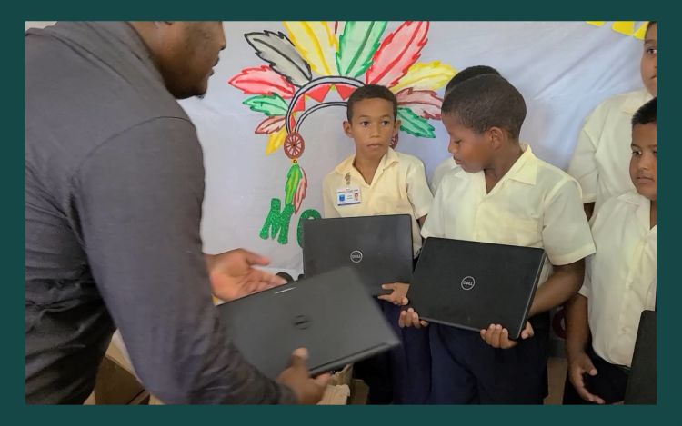 Students in Guyana receiving the electronics donated by ecobee and Generac.