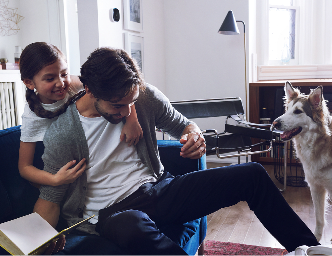 A couple plays with their dog.
