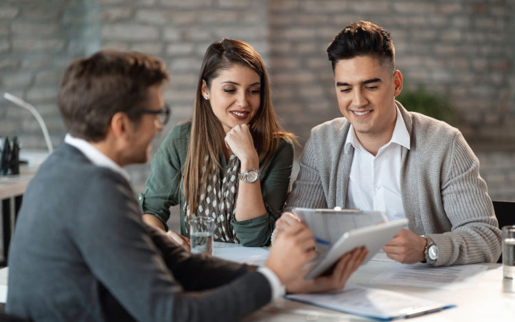 Image of a couple being advised by their insurance agent.