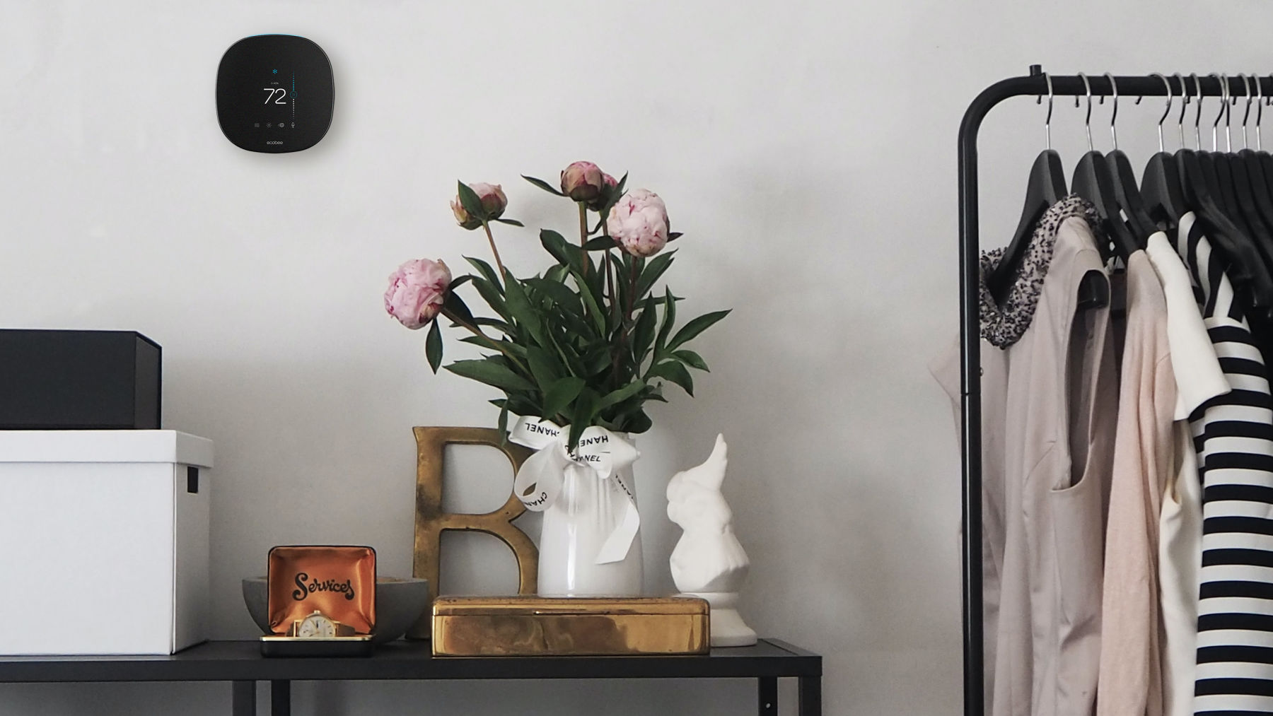 ecobee thermostat on the wall set next to flowers in vase