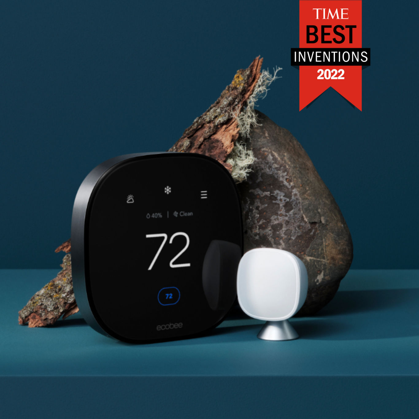 ecobee Smart Thermostat Premium with SmartSensor on a blue background against a rock with a mossy piece of tree bark. A red banner reads “TIME BEST INVENTIONS 2022”. The thermostat displays 72 degrees, and a clean air reading.