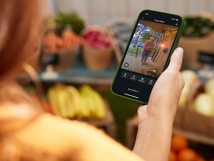 A person checking live view of ecobee's Smart Doorbell Camera on their phone on the ecobee app.
