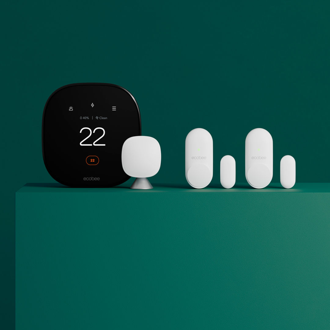 Smart Thermostat Premium, SmartSensor and a pair of Smart Sensors for doors and windows displayed on a green background.