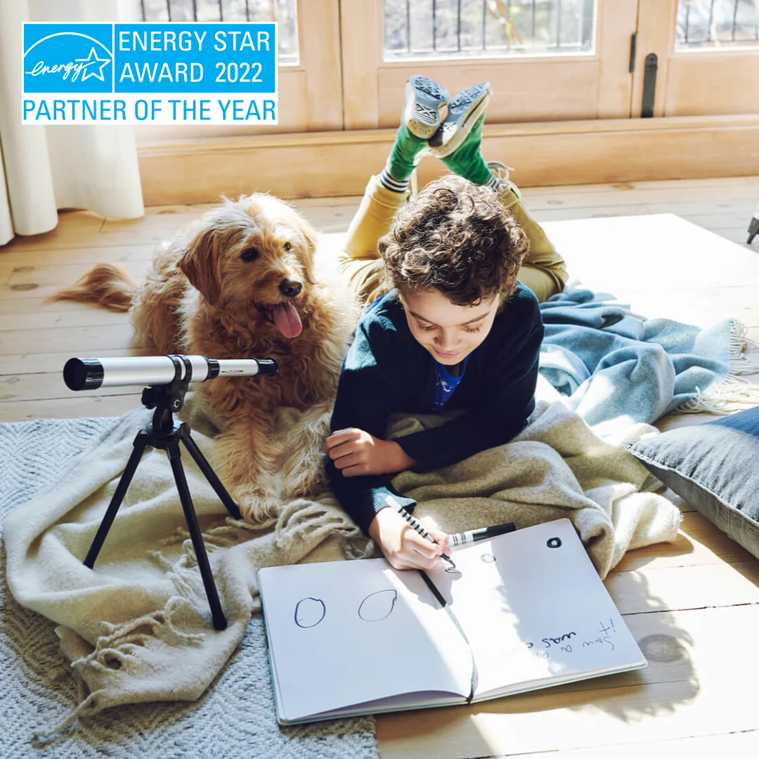 A child plays on the floor with a dog; the Energy Star Partner of the Year award logo is visible.