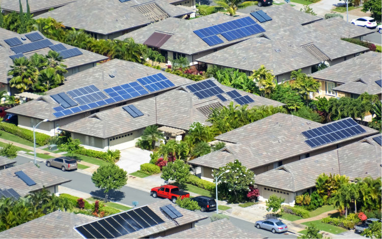 Solar panels on roofs in suburban neighbourhood.