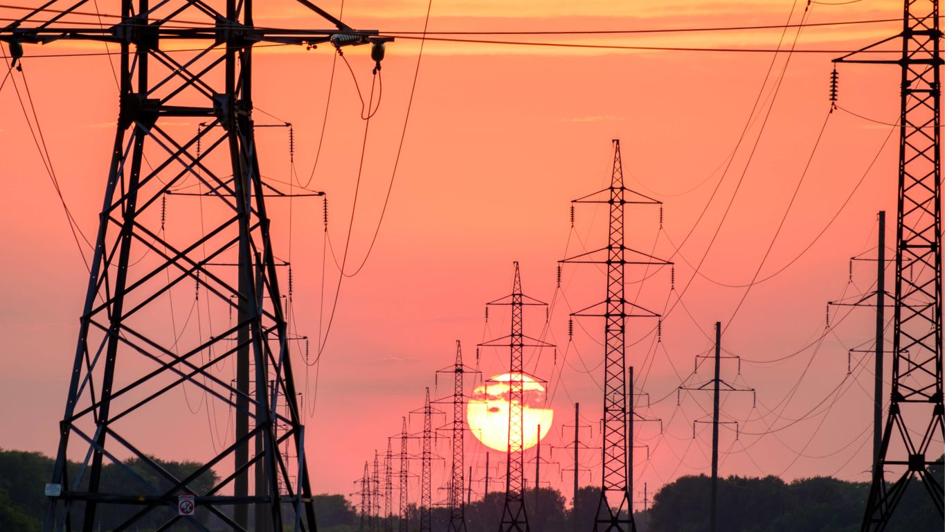 Image of power lines with sunset backdrop