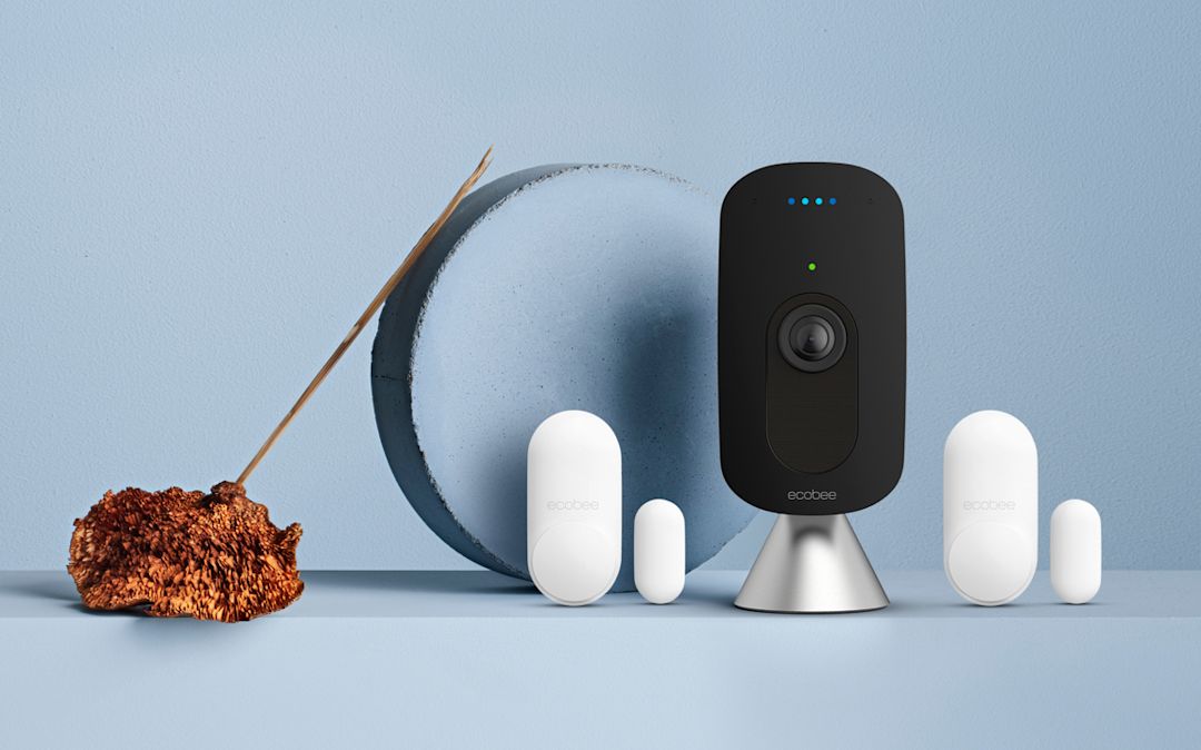 ecobee SmartCamera and 2 ecobee SmartSensors for doors & windows on a blue background.