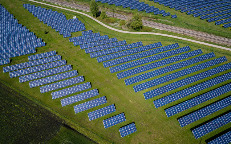 Aerial view of a large solar power plant. The scientific consensus is that the economy must be totally decarbonized by 2050 to stave off the worst effects of global warming. eco+ helps improve home energy efficiency for a better future.