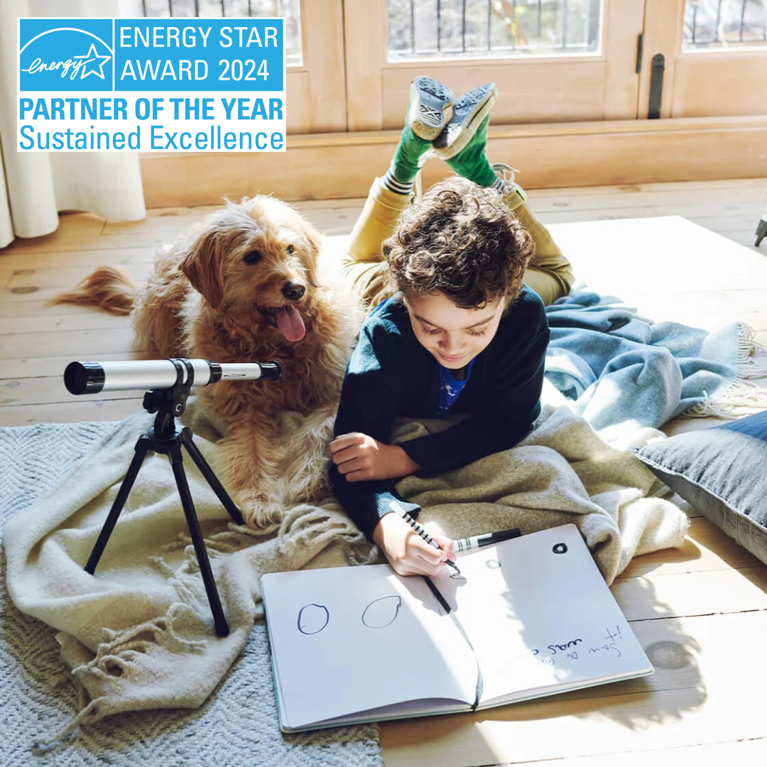 a child plays on the floor with a dog. the energy star award banner is in the top left corner, which reads "energy star award 2023 partner of the year, sustained excellence"