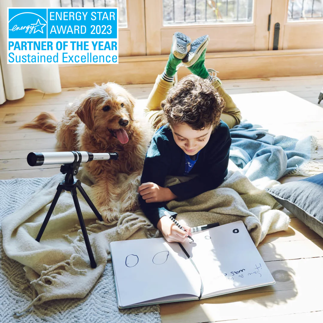 a child plays on the floor with a dog. the energy star award banner is in the top left corner, which reads "energy star award 2023 partner of the year, sustained excellence"