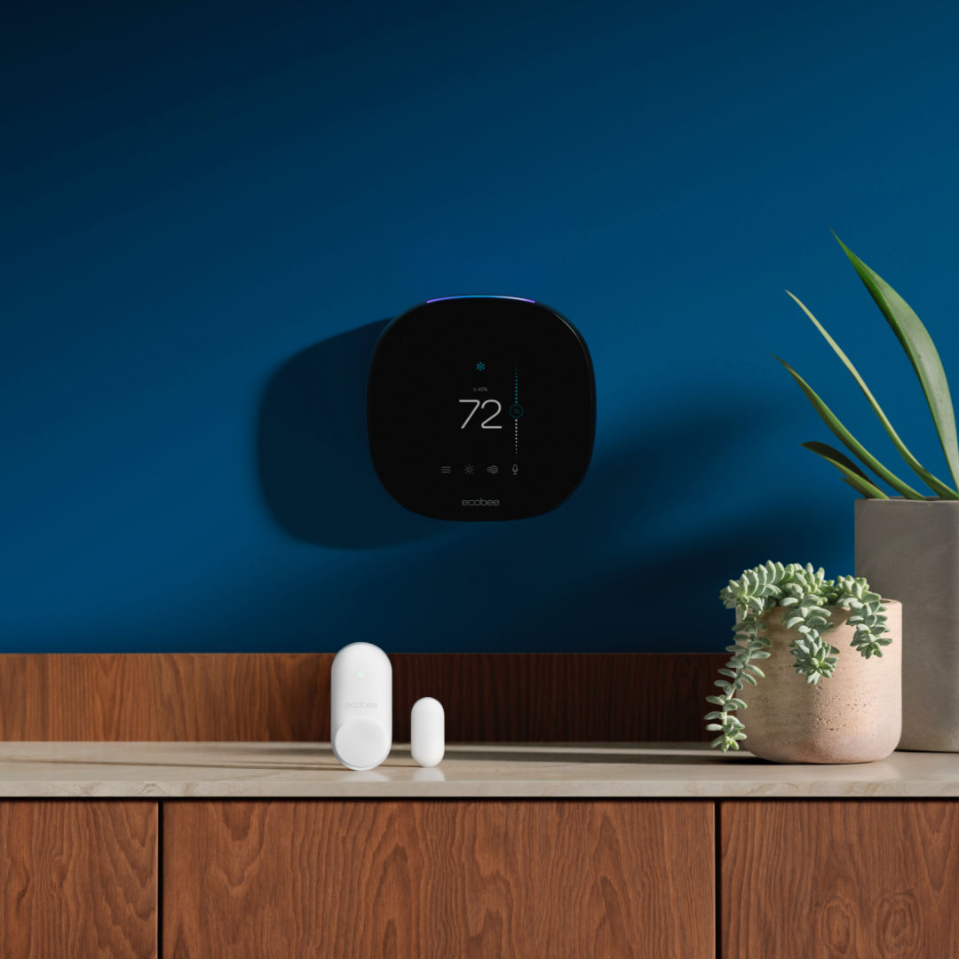 ecobee thermostat and sensors on a blue background