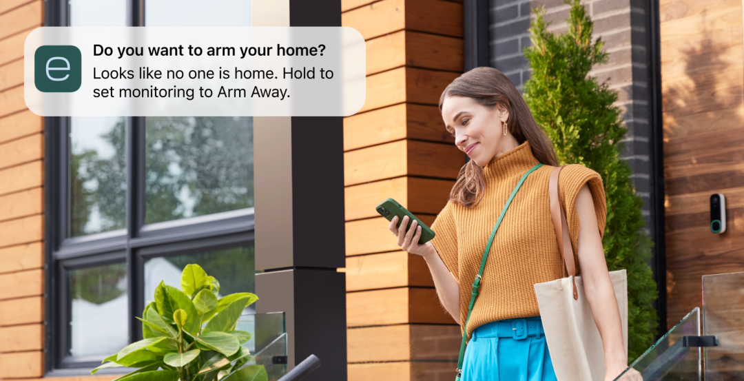 A woman checks her phone while out; the ecobee app asks if she wants to arm her home